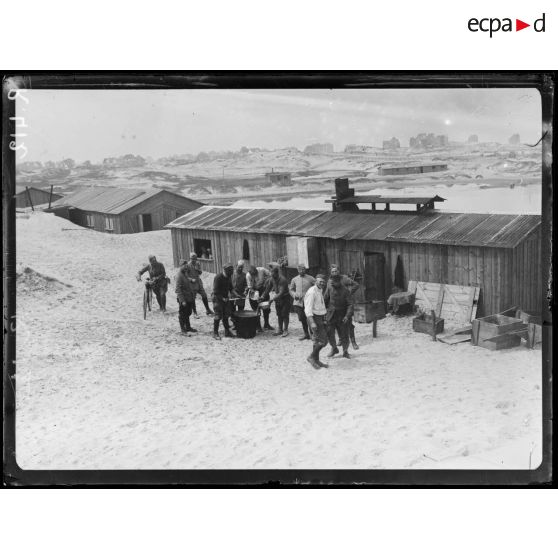 Près de Coxyde-Bains (Belgique). Camp français dans les dunes dit camp Bador.  La cuisine du camp, au fond les maisons de Coxyde-Bains. [légende d’origine]