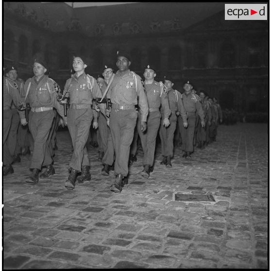 Le défilé des volontaires du 1er Bataillon français des Nations Unies (Bataillon de Corée) lors d'une prise d'armes dans la cour d'honneur de l'Hôtel national des Invalides.