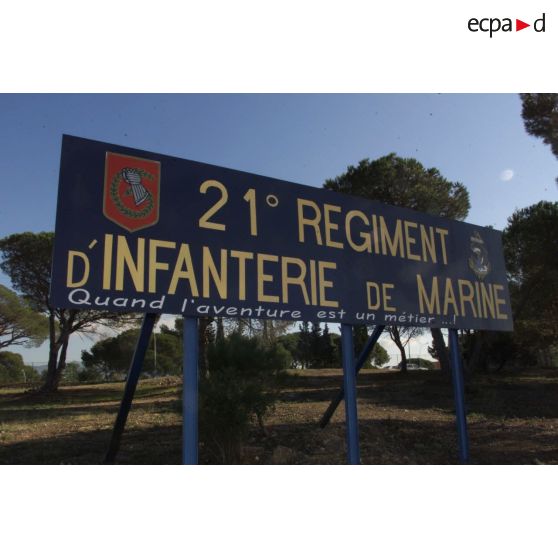 Préparatifs au départ en Afghanistan pour le 21e RIMa (régiment d'infanterie de marine). Panneau d'entrée du camp du 21e RIMa, portant son insigne avec la devise "croche et tient" et le slogan "Quand l'aventure est un métier".