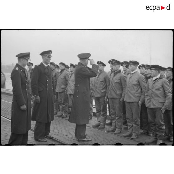 Sur un quai de Wilhelmshaven, les amiraux Doenitz et Carls passent en revue l'équipage de l'U-19 (ou U-3).