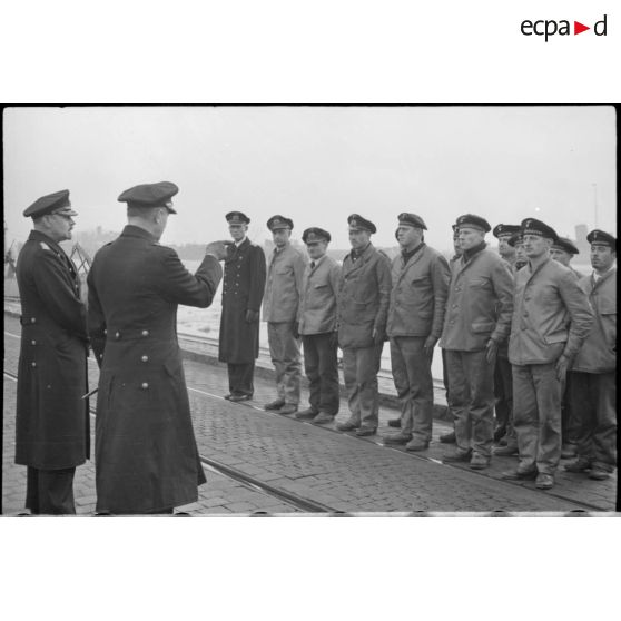 Sur un quai de Wilhelmshaven, les amiraux Doenitz et Carls passent en revue l'équipage de l'U-19 (ou U-3).