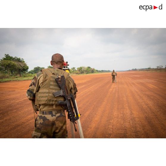 Soldats du 25e RGA du détachement logistique du GTIA (groupement tactique interarmes) Turco, mesurant au moyen d'un théodolite et d'une mire topographique le niveau du sol de la piste de l'aérodrome de la POD (plateforme opérationnelle défense) de Bambari, lors des travaux d'entretien à effectuer.