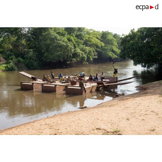 Habitants traversant la rivière Baibou à bord du bac de Gimbissi pour se rendre aux champs. Celui-ci a été réfectionné par les hommes du 3e RG du GTIA (groupement tactique interarmes) Turco.