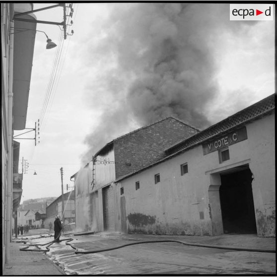 Intervention de sapeurs-pompiers durant un incendie dans un village.