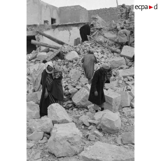 La population civile récupère des objets dans les ruines de la ville de Gafsa.