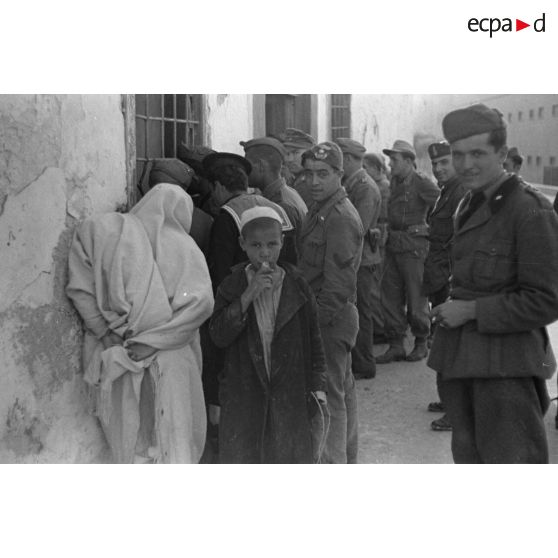 A Tripoli, un attroupement de soldats germano-italiens devant un bâtiment.