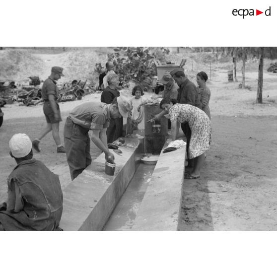 Des mécaniciens du Nachschubkolonne Abteilung 909 au lavoir en compagnie de civils.