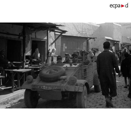 Dans une rue de Kairouan, une Kübelwagen de la 10.Panzer-Division (insigne peint sur l'avant du véhicule).