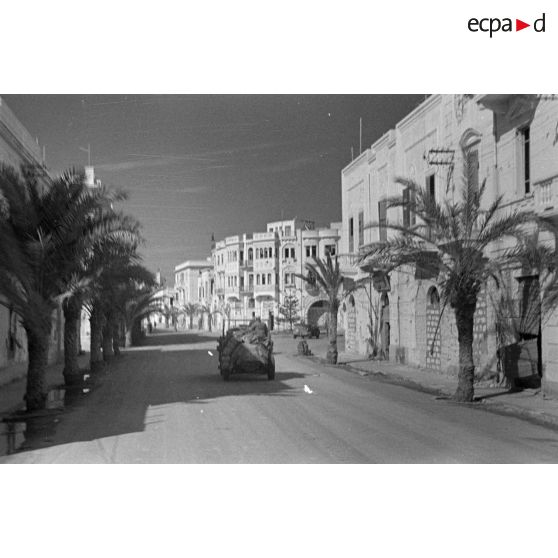 Des véhicules de la 21e division blindée allemande (21-Panzer-Division) roulent dans les rues de la ville.