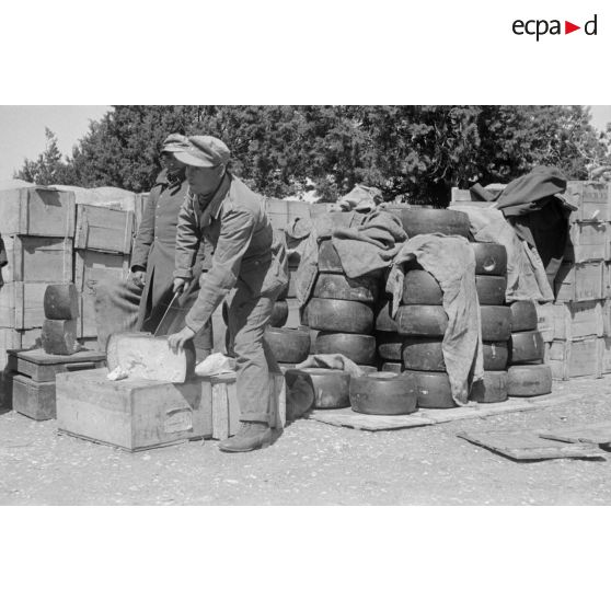 Un soldat découpe des fromages.