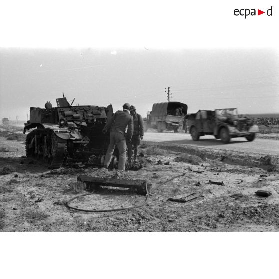 Des soldats allemands inspectent l'épave d'un char américain M3 Stuart détruit.