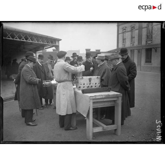 Bois Colombes, usines Hispano Suiza. Les journalistes regardent fonctionner des moteurs d'avions testés sur des bancs d'essais (spa 60 m 1451). Un ingénieur de la firme automobile exxplique ensuite aux journaliste le fonctionnement du moteur (spa 60 m 1452). [légende d'origine]