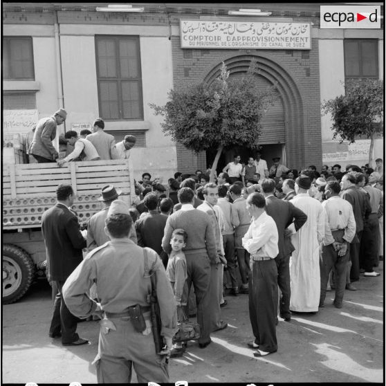 La population égyptienne attend la distribution de vivres au comptoir d'approvisionnement du personnel de l'organisme du canal de Suez.