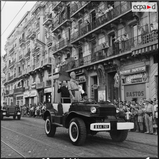 Cérémonie du 14 juillet à Alger. Robert Lacoste salue la foule présente dans les rues d'Alger.