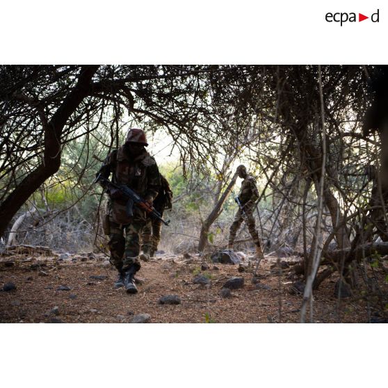 Des soldats nigériens ratissent un ouadi dans la région de Fadar-Fadar, au Burkina Faso.