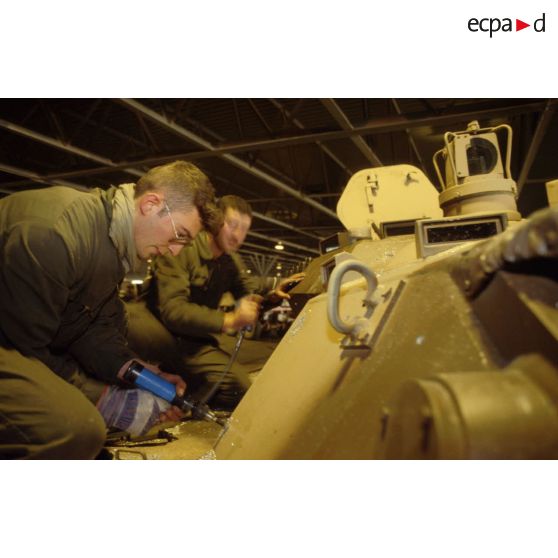 Des soldats du détachement matériel du GSL (groupement de soutien logistique) réalisent le surblindage d'un blindé de reconnaissance AMX-10 RC dans les environs de CRK (camp du roi Khaled).