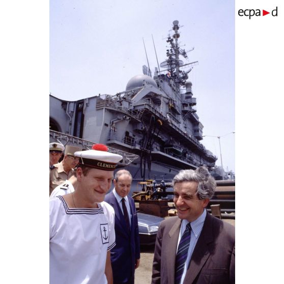 Jean-Pierre Chevènement, ministre de la Défense, en conversation avec un marin du PA (porte-avions) Clemenceau, sur le quai à Djibouti.