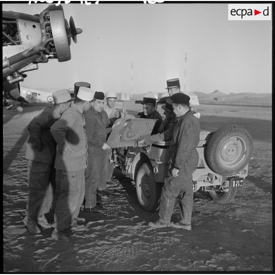 Légionnaires et pilotes autour de l'insigne de la légion étrangère qui était sur l'avion de transport Junkers Ju-52.