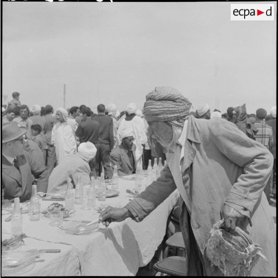 Un homme mange à la table du banquet.