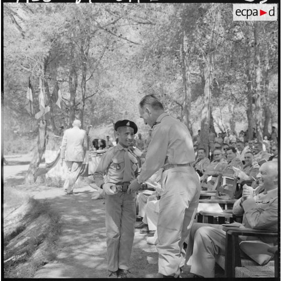 Le général Huet, commandant de la zone nord algéroise et la 7e division mécanique rapide (7e DMR) remet un prix d'honneur à un élève de 6e moderne, dans les jardins de l'Ecole militaire préparatoire nord-africaine (EMPNA) de Koléa.