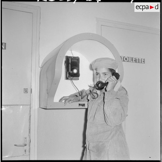 Portrait d'une jeune femme qui parle au téléphone de la cabine téléphonique de la section administrative spécialisée (SAS) du Zaccar.