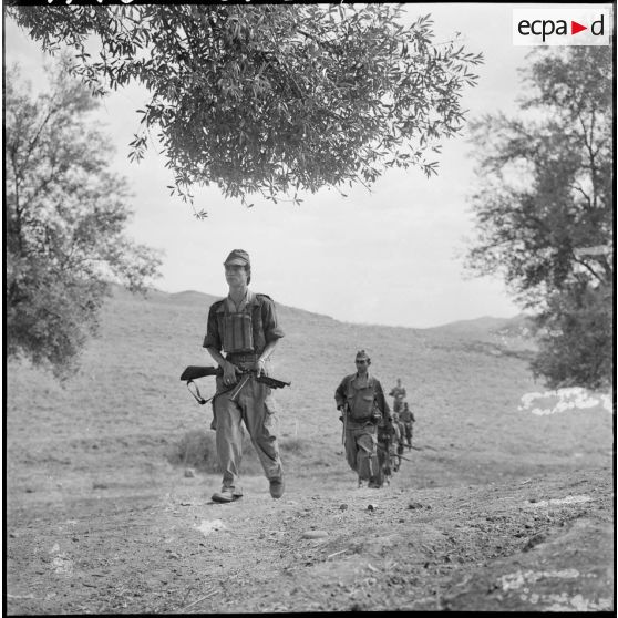 Un groupe de harkis en patrouille en pleine campagne.