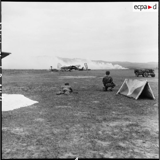 Le photographe Jean Péraud et le caméraman Pierre Schoendoerffer en action près du terrain d’aviation de Diên Biên Phu pendant des tirs de l’artillerie vietminh.