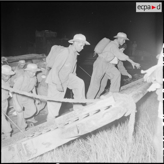 Des prisonniers de l'Union française libérés par le Vietminh à Viet Tri débarquent de nuit d'un chaland.