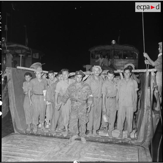 Des prisonniers de l'Union française libérés par le Vietminh à Vietri débarquent de nuit d'un chaland.