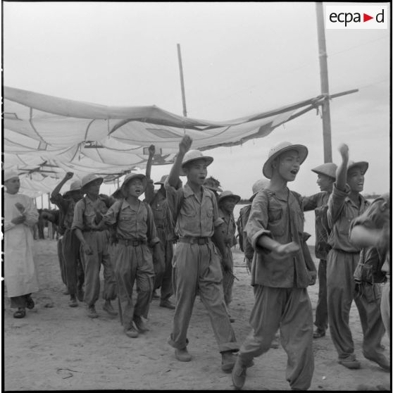 A peine libérés, les prisonniers vietminh se dirigent vers des centres d'accueil en entonnant des chants de victoire.