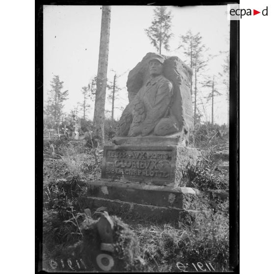 [Dans un cimetière : monument funéraire.]