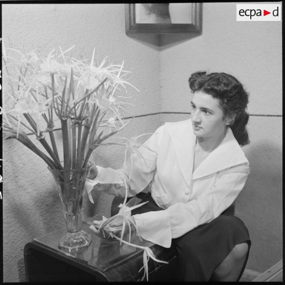 Christiane Sacquet, infirmière, arrange un bouquet de fleurs dans sa chambre.