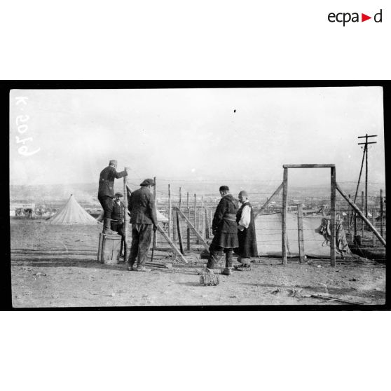 Camp de Zeitenlick. Prisonniers (macédoniens suspects) construisant eux-mêmes leur prison, composée de petites tentes entourées de réseaux de fils de fer barbelés. [légende d'origine]