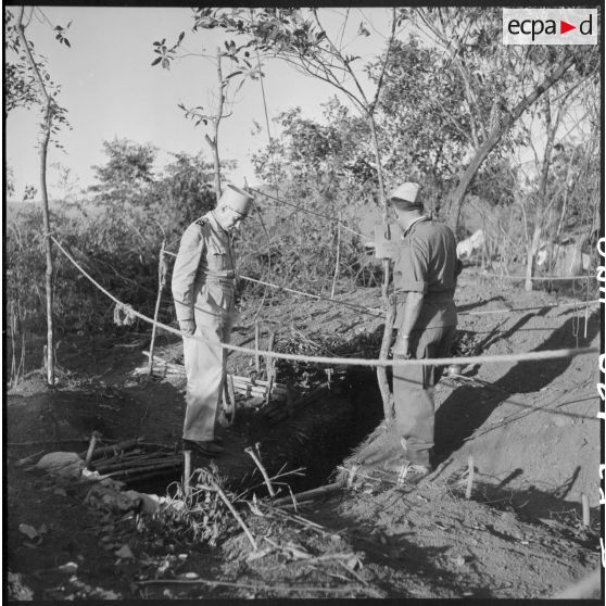 Le général Navarre, commandant en chef en Indochine, devant l'abri du centre radio d'un point d'appui du camp fortifié de Diên Biên Phu.