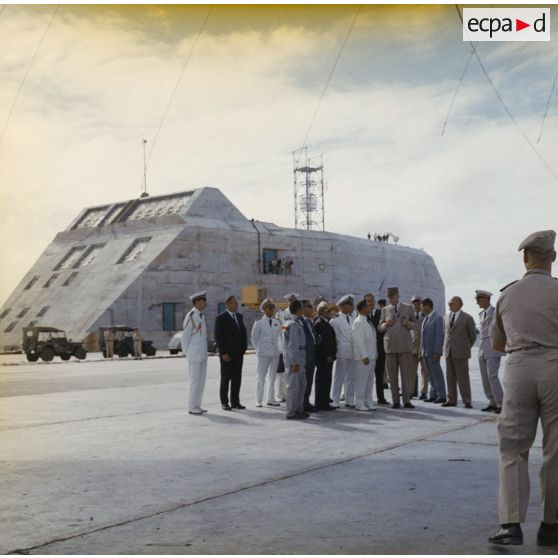 Le général Charles De Gaulle, président de la République, visite le site du poste d'enregistrement avancé (PEA) Denise, en compagnie de Jean Viard, directeur des essais. En hauteur, les câbles d'arrimage du ballon du prochain tir Bételgeuse.