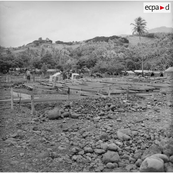 Construction et maçonnerie, bétonnage. Mise en place des infrastructures. Camp de tentes. Militaires du 5e régiment mixte du Pacifique (5e RMP). Peut-être la construction du camp d'Arue, vers 1963-1964.