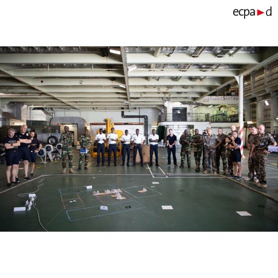 Des officiers français et sénégalais participent à un briefing sur carte à bord du porte-hélicoptères amphibie (PHA) Tonnerre (L9014) à N'Gazobil, au Sénégal