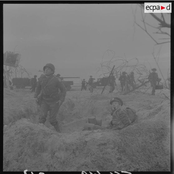 Sur le tournage du film Le jour le plus long. Acteur jouant le rôle d'un correspondant de guerre américain, et acteur jouant le rôle d'un correspondant de guerre britannique (british war correspondant), tel Cornelius Ryan, auteur du livre The longest day.