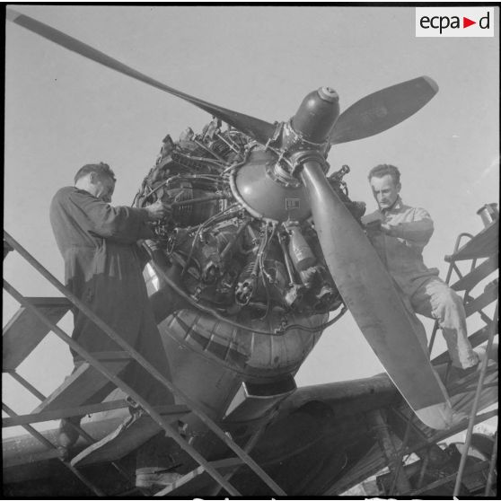 Des mécaniciens du groupe de chasse II/18 Saintonge assurent la maintenance du moteur en étoile d'un Douglas A24 (Wright R-1820 Cyclone 9).