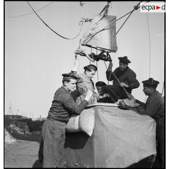 Des marins préparent la nacelle d'un ballon d'observation.