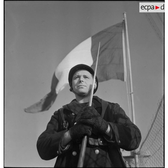 Portrait en contre-plongée d'un marin, sentinelle de la défense côtière dans la région de Brest.