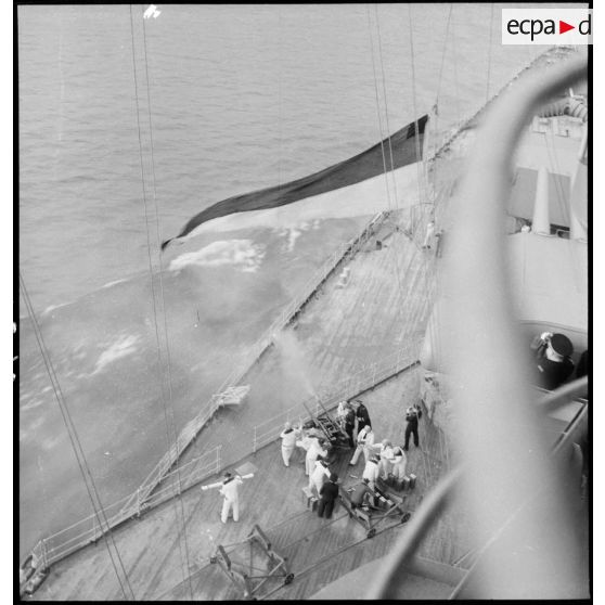 Vue en plongée depuis la superstructure sur les servants d'un canon double antiaérien de 37 mm à bord du cuirassé Dunkerque.