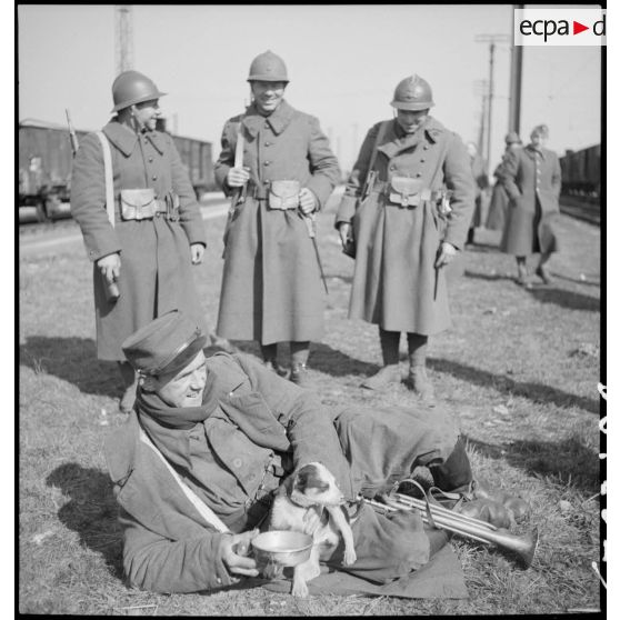 Photographie de groupe de soldats près d'une voie ferrée en gare de Trappes.