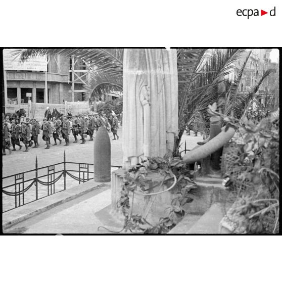 Le 1er REI défile dans les rues de Sidi Bel-Abbès. La troupe passe devant le monument aux morts de la ville.