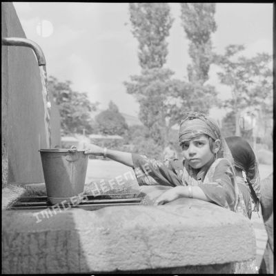 Une petite fille à la fontaine d'un village du Constantinois.