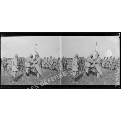 Le général Passaga décore de la Croix de Guerre le fanion du roupe de brancardiers divisionnaire de la 42e DI. [légende d'origine]