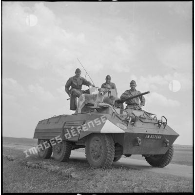 Quatre soldats posent sur leur automitrailleuse. [légende d'origine]