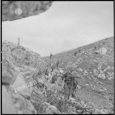 [Soldats du 2/8e RIM en progression dans une zone escarpée au cours d'une opération en Kabylie.]