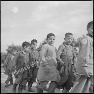 [Groupe d'enfants algériens marchant à Aïn Skhouna.]