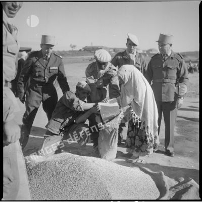 [Distribution de grain auprès d'une Algérienne par des soldats près de Saïda.]